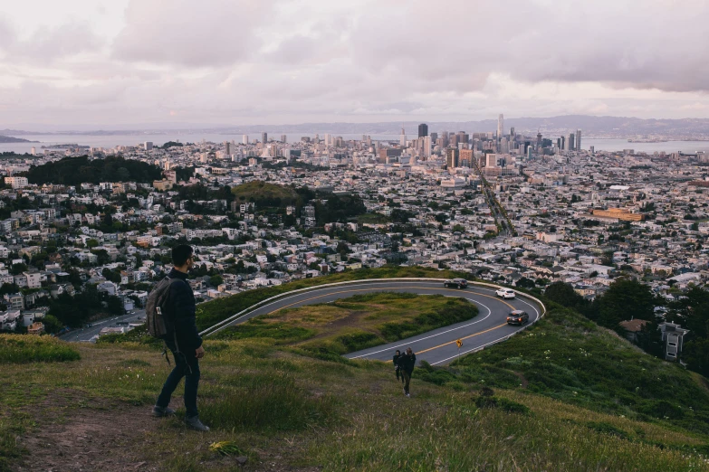 a man is overlooking the city from the hill