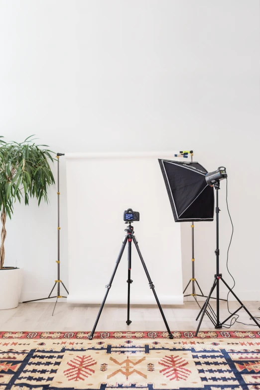 a studio room with two lights, a poboard and a tripod