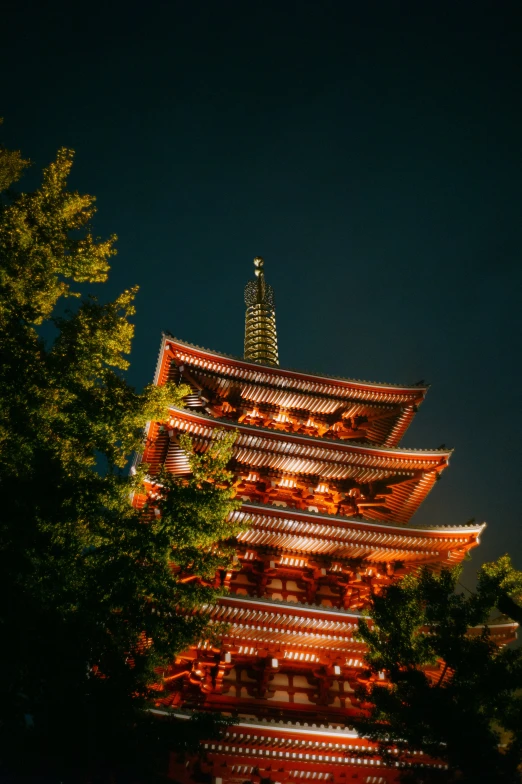 the structure of an oriental building is illuminated at night