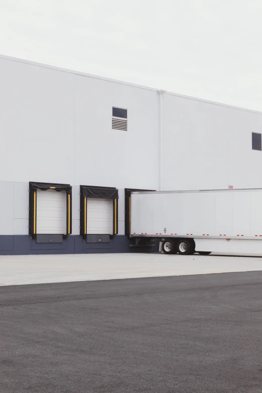 a big white truck parked in front of a building