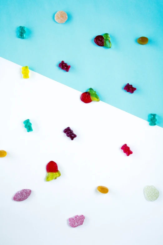 many pieces of candy and confetti are on the white surface