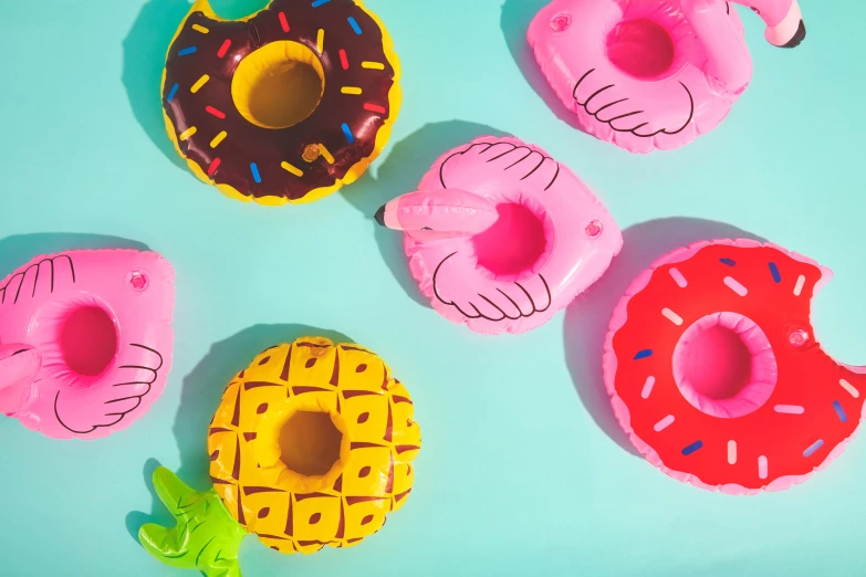 a group of four donuts sitting on top of a blue surface