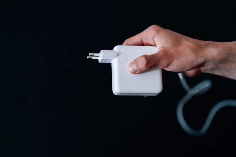 the hands holding the charger have two plugs