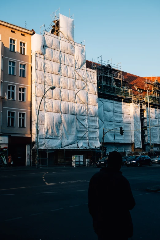 a building being constructed and covered with plastic wrap