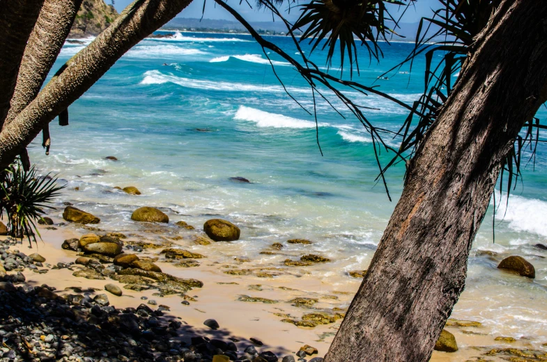 the view from a beach looking out towards the ocean