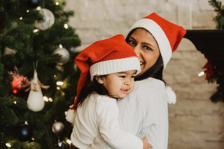 the child is getting a hug from her mother