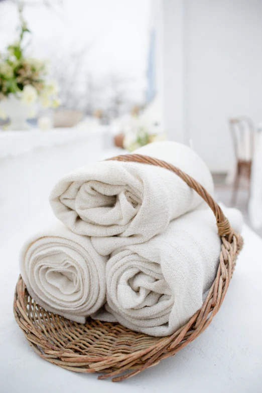 towel folded in a wicker basket sitting on a counter