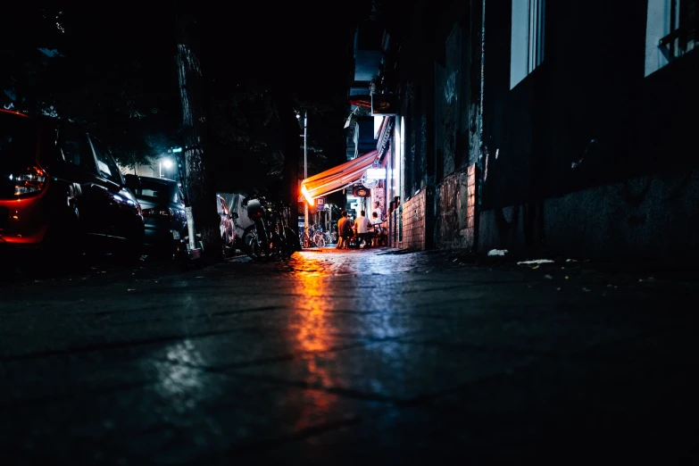 dark city alley with traffic lights and vehicles