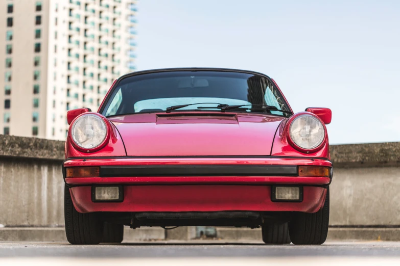 the front end of a red porsche sports car