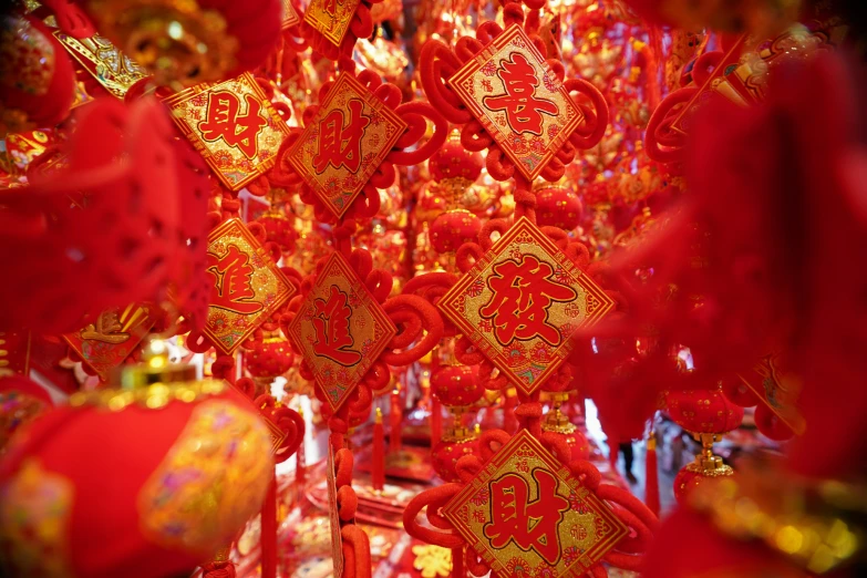 chinese decorations are hanging on a ceiling