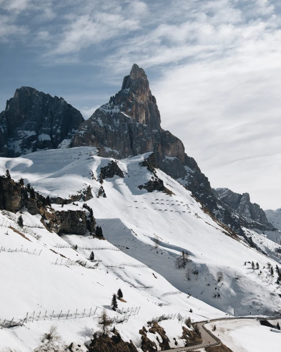 a mountain filled with snow with lots of tall buildings