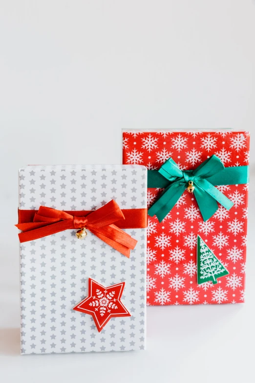 christmas gift boxes with green ribbons on them