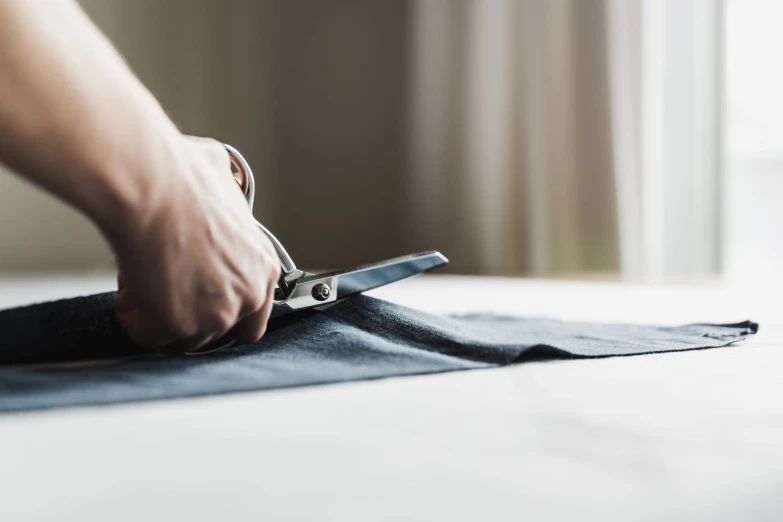 a person holding a pair of scissors in each hand