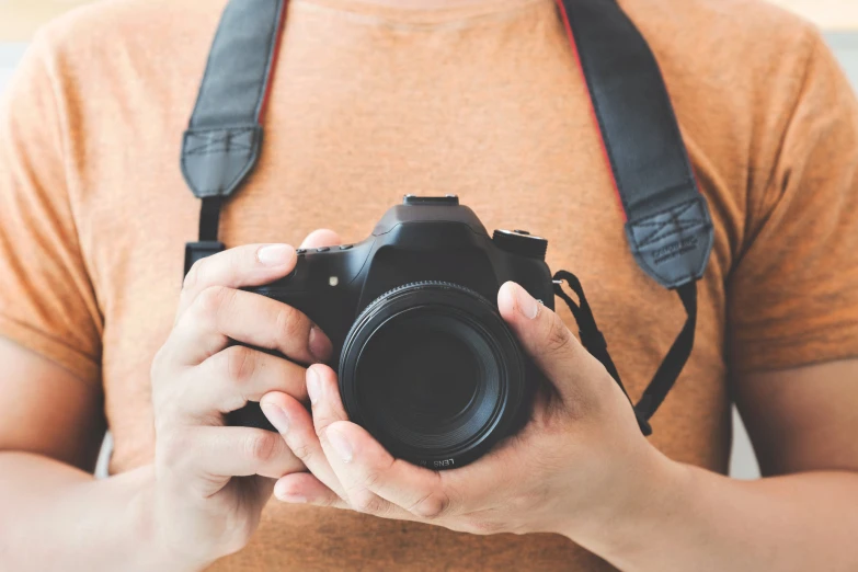 a pographer is holding his camera up