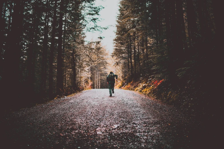 a person riding a skate board on a gravel road