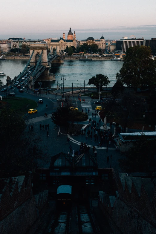 a river running alongside a city with bridges