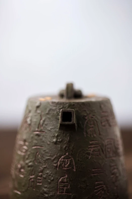 a clay object that has writing on it