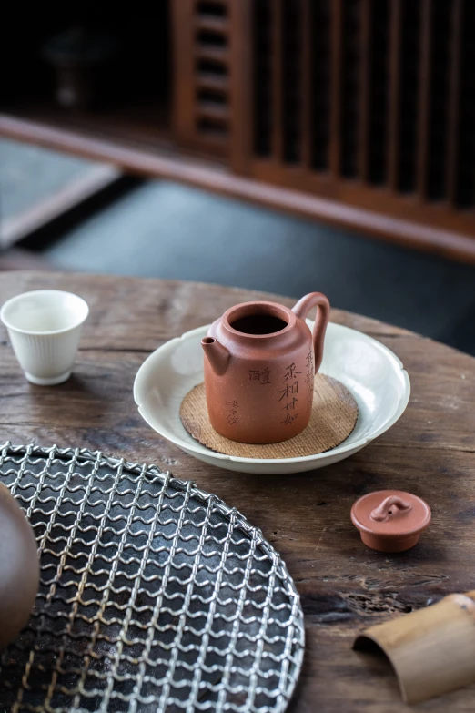 teacup on a saucer with a pair of wooden scissors