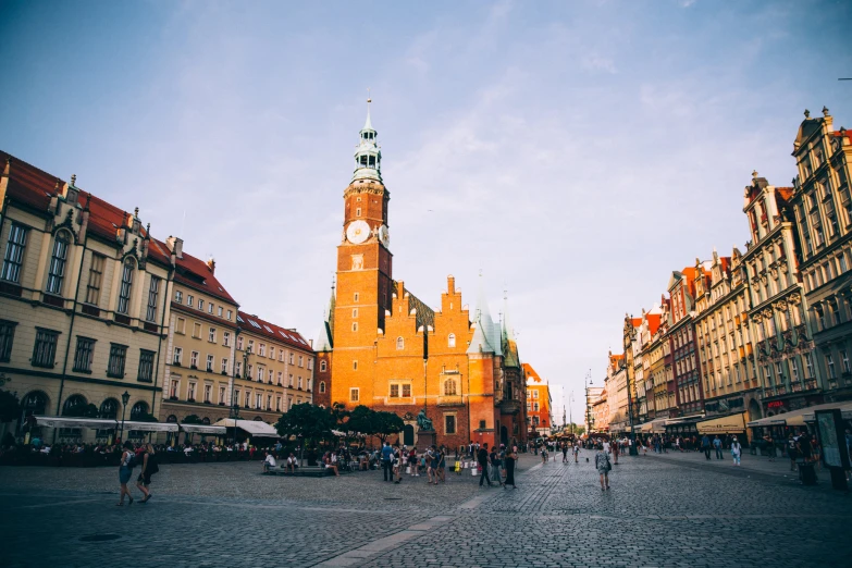 an old city street with people and a clock tower