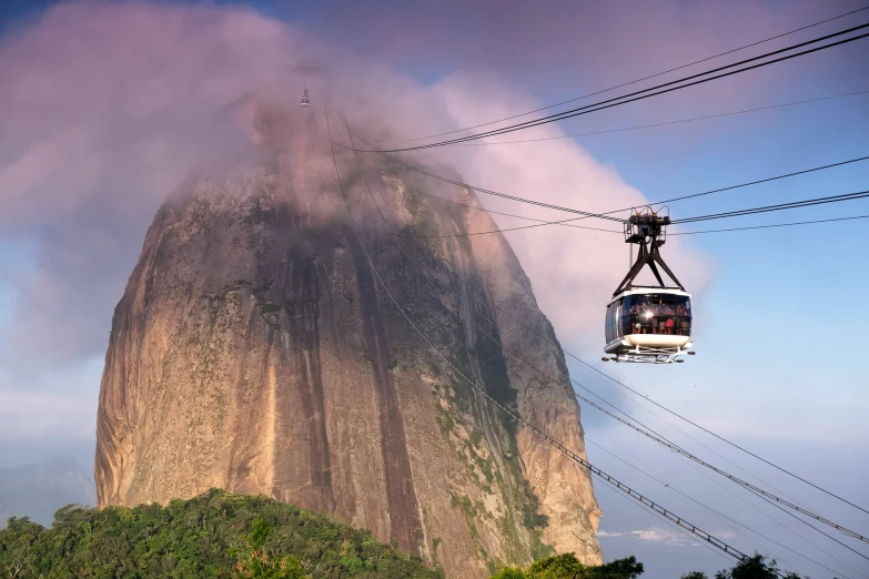 a cable car with people going up and down a hill