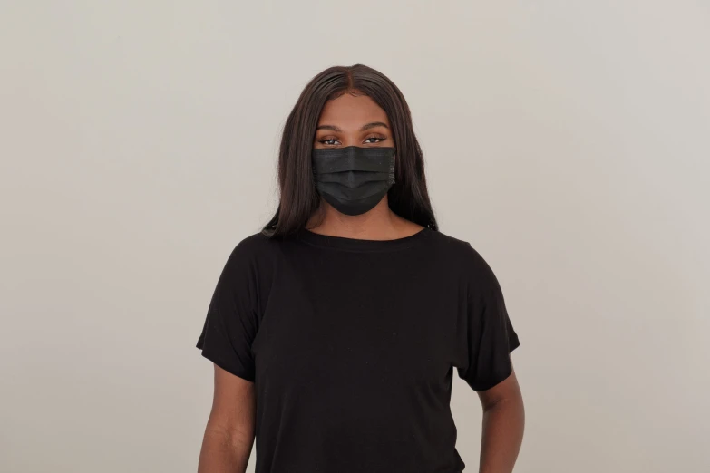 a woman wearing a black mask in the middle of her face