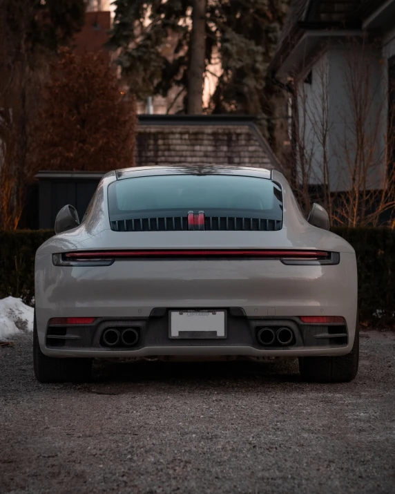 there is a silver car parked in the driveway