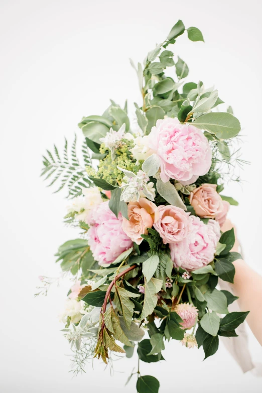 a woman holding a bouquet of flowers on top of her