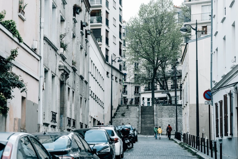 the sidewalk in an urban city has cars on it