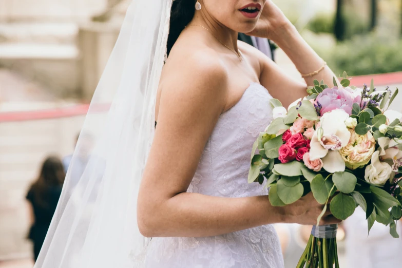 a bride with wedding bouquet and bridal attire