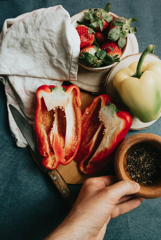 a wooden spoon is full of a sliced pepper