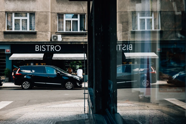 cars parked outside a restaurant in a city