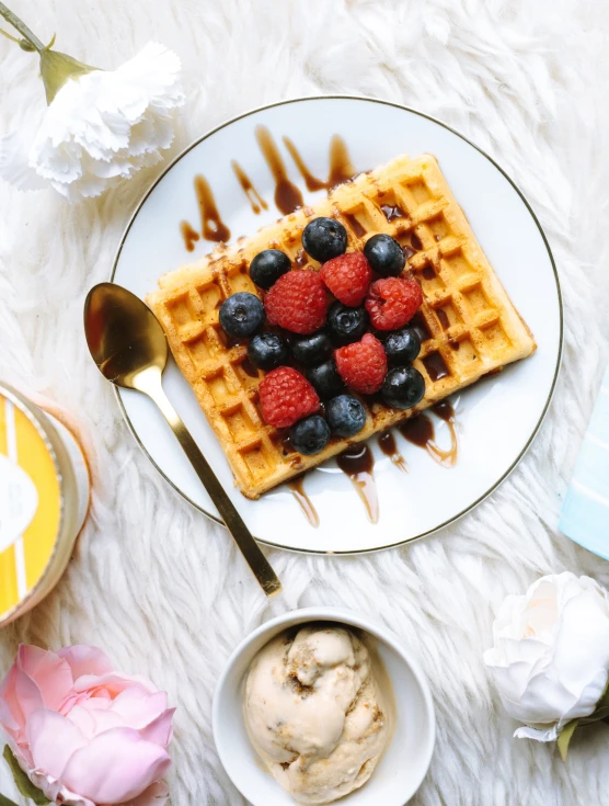 a white plate topped with waffles covered in berries