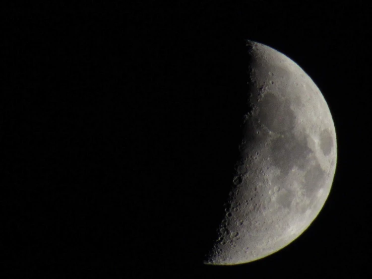 a crescent moon is shown with the sun rising behind it