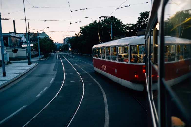 the white and red trolley has stopped at the stop light