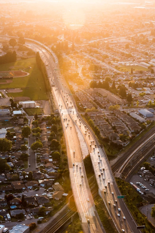 a highway with several lanes and lots of traffic traveling through the city