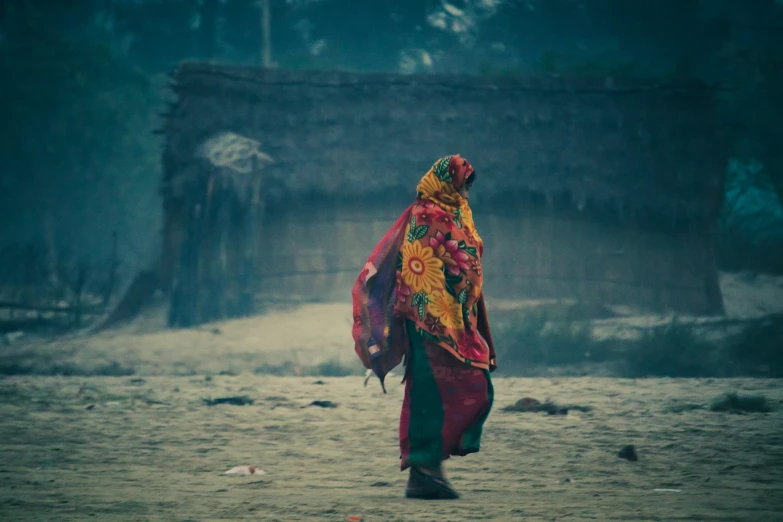 there is a woman walking down the road in the rain