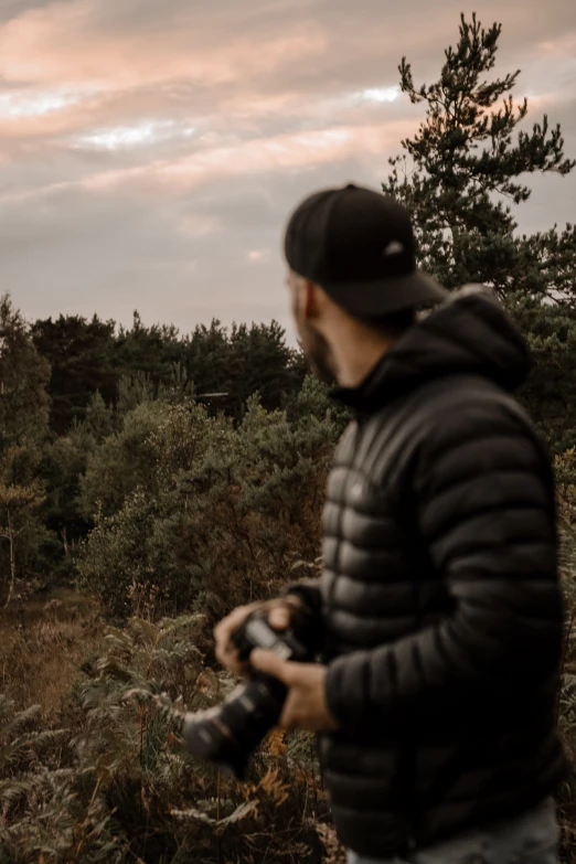 a person is taking a picture in the woods