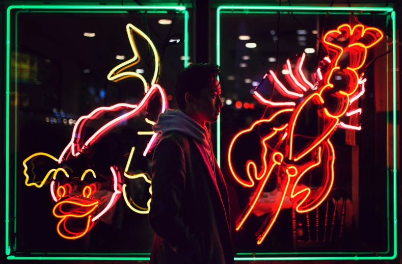 a person standing in front of neon lights