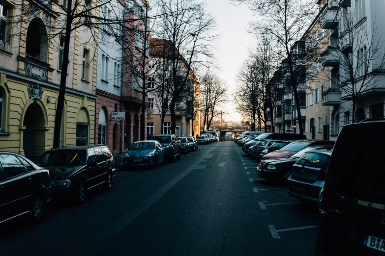 a group of cars that are parked in the street