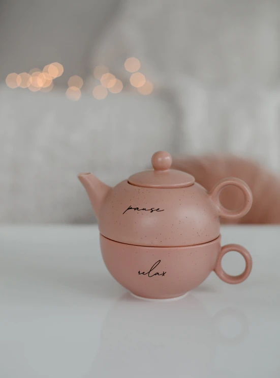 a pink teapot that says namja