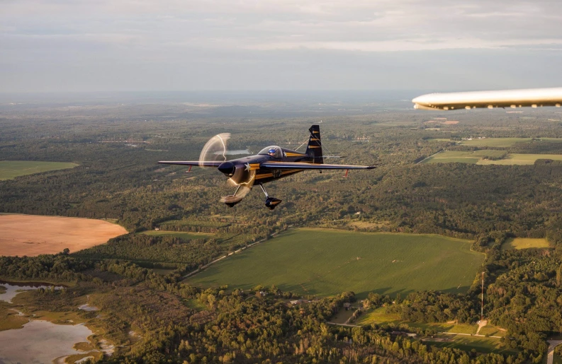 a large plane flying through the air over land