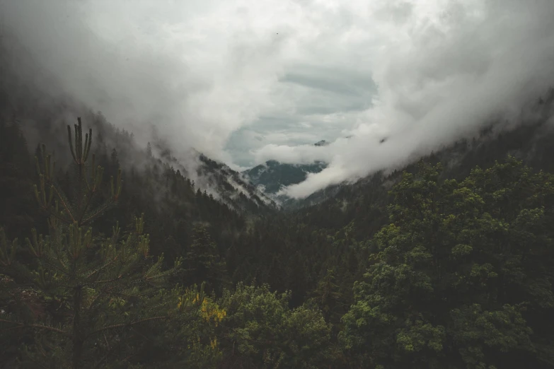 an overcast day in the mountains with thick clouds