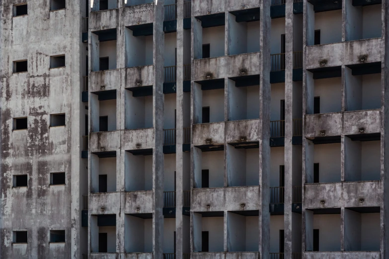 the side of an old run down building with many windows