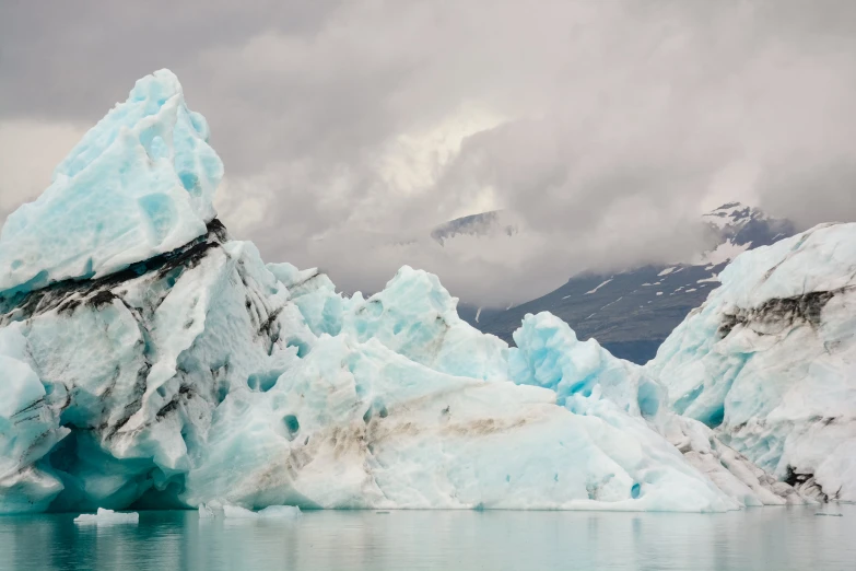 a blue iceberg that is in the water