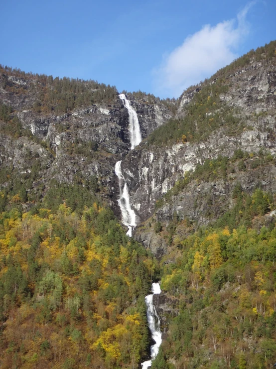 a waterfall running from the bottom of a steep mountain