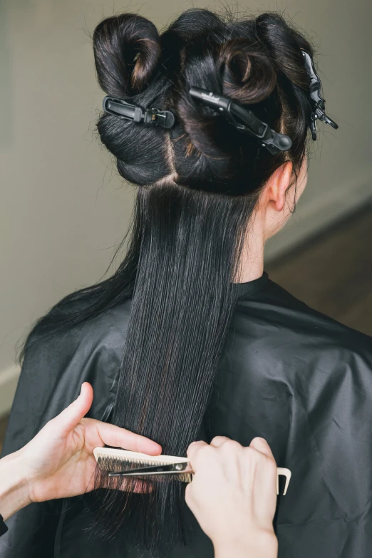 woman with scissors  her hair while looking back