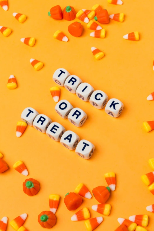 two letter words that read trick or treat with candy and corn on the side