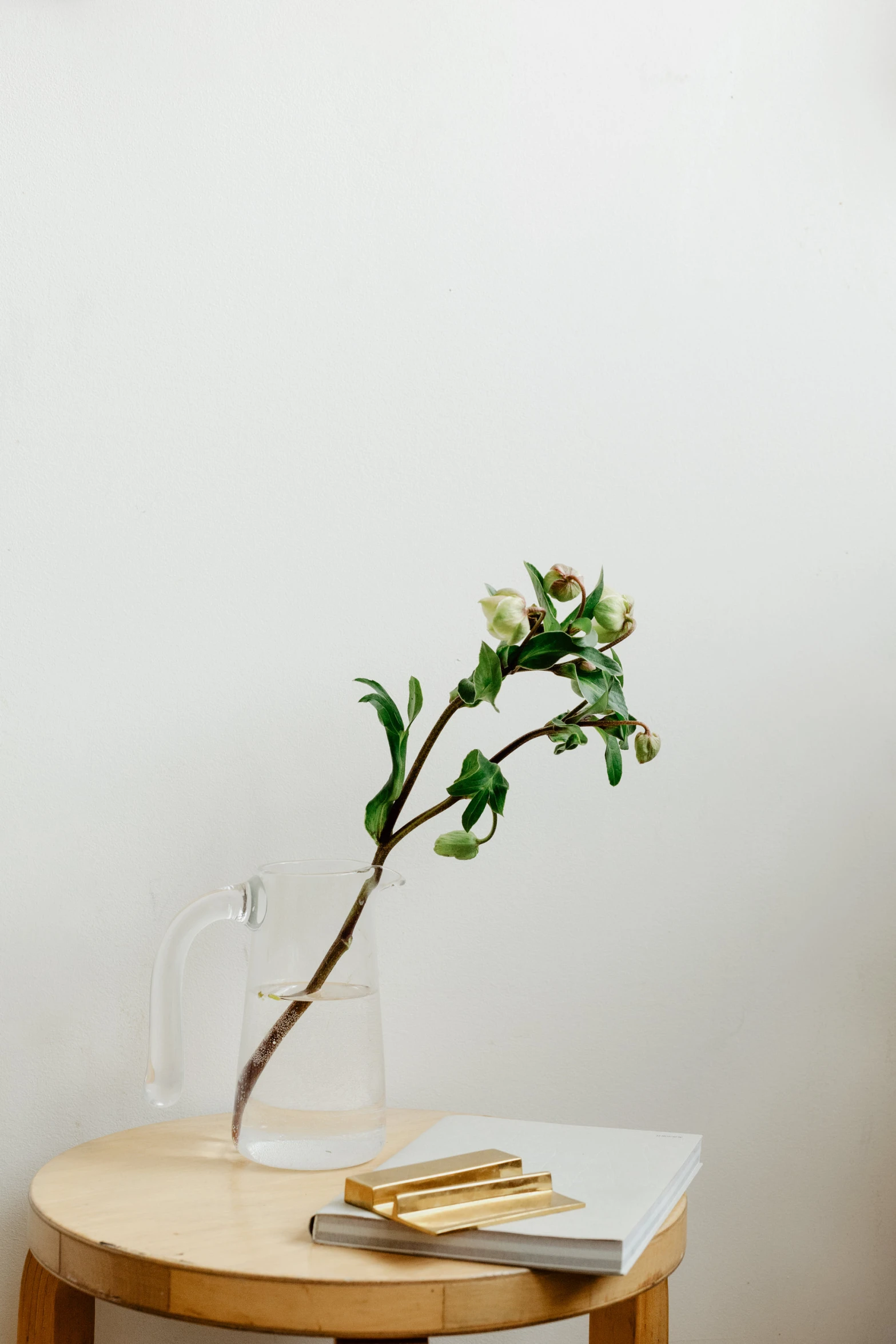 vase on table, containing small white flowers and a golden cigarette