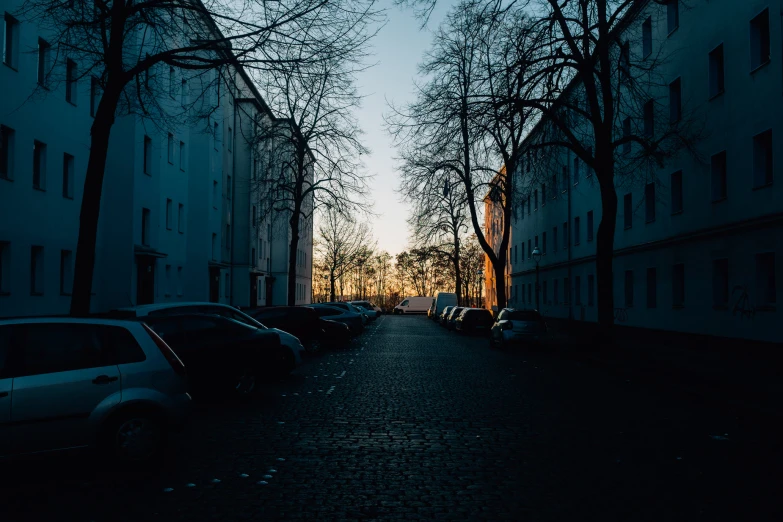 a city street is lined with parked cars