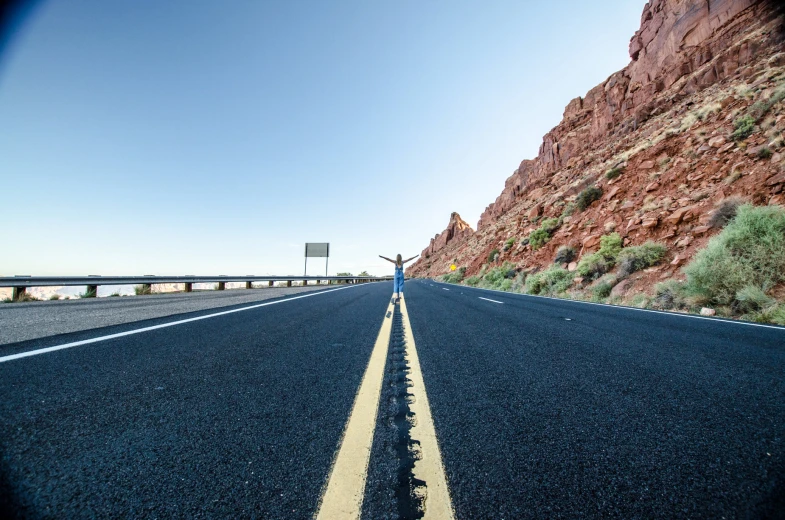 a road with a sign on it that reads las vegas and is next to red mountains